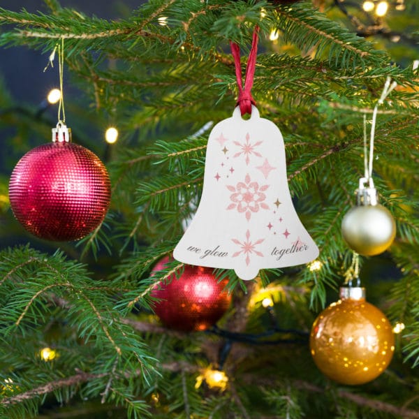 wooden ornament wood bell hanging on tree we glow together whisper